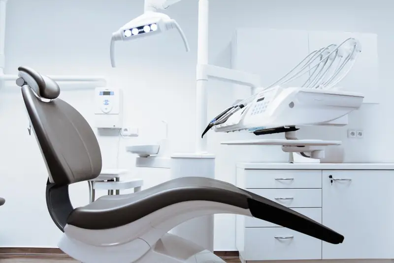 A clean, bright dental treatment room with a dental chair